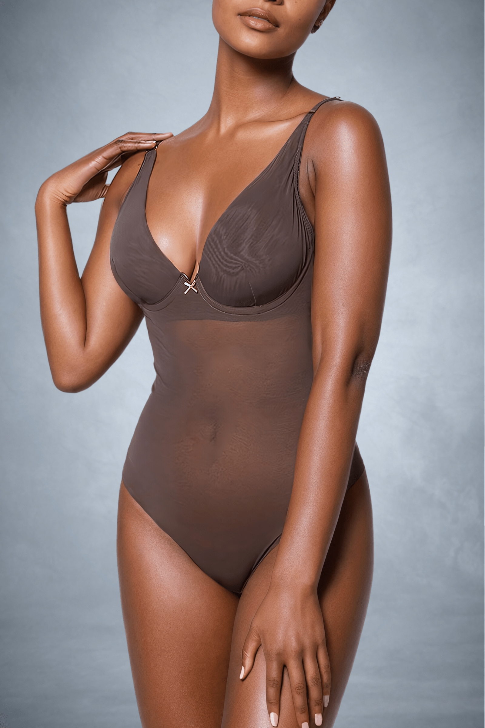 Front view of a faceless woman wearing a seamless shapewear bodysuit in colour brown with plunge bra | ENDER LEGARD