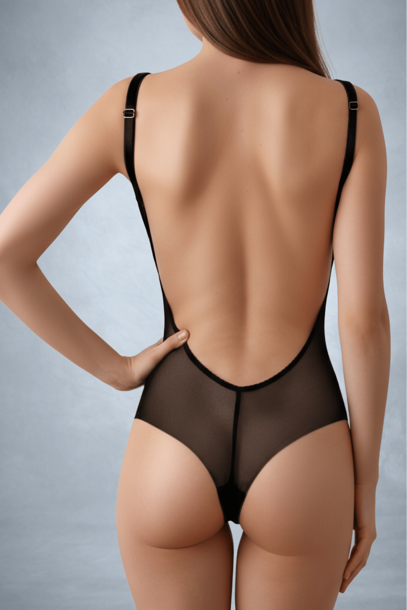 A faceless woman with one hand on her hip wearing a black mesh bodysuit with an open back as viewed from the back | ENDER LEGARD