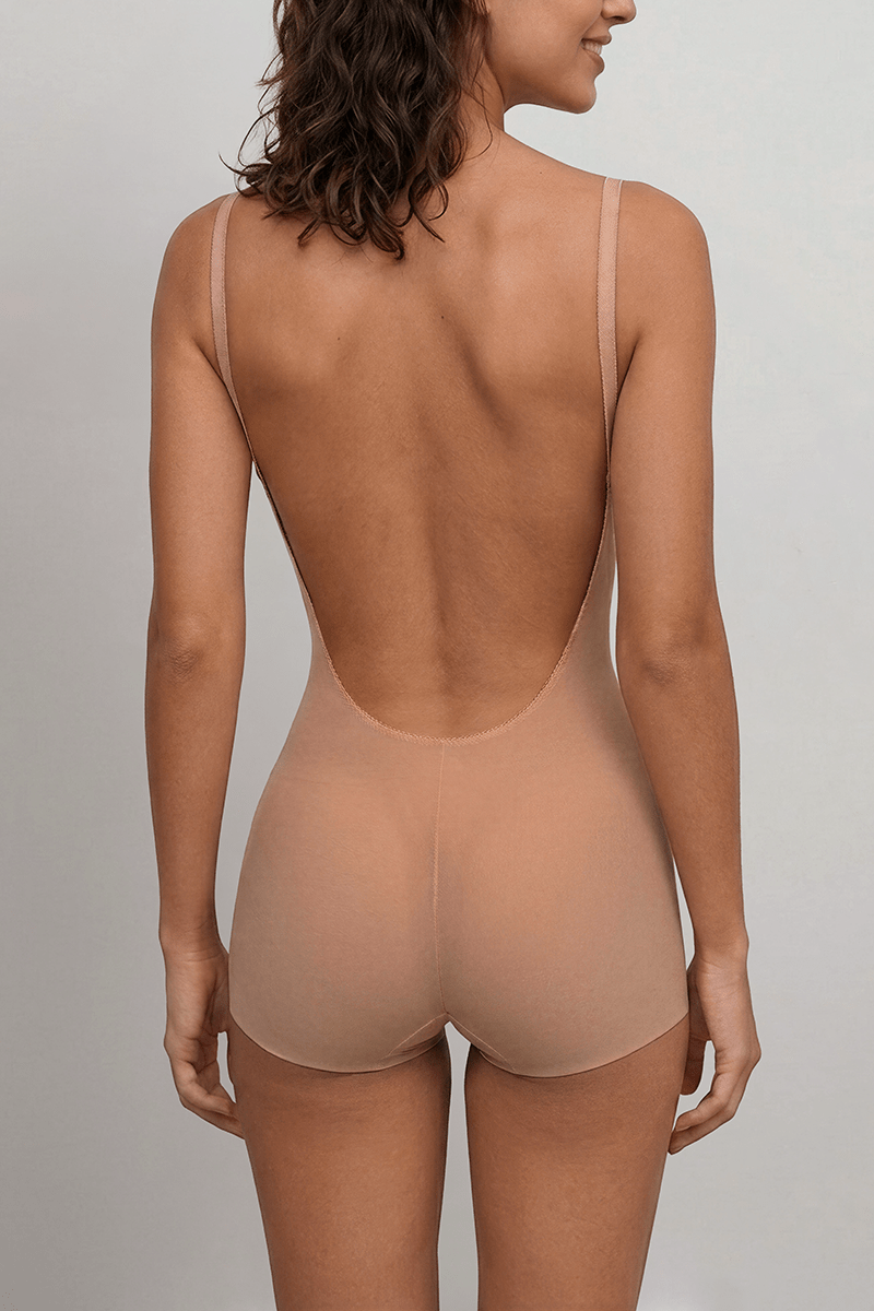 Seamless low-back shapewear bodysuit with full brief coverage and invisible edges for backless and unlined dresses.