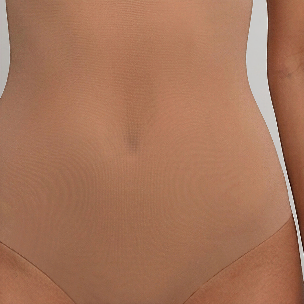 Close-up of the FRANKIE Nude bodysuit's sheer mesh midriff panel across the stomach and hip, with no separate waistband seam.