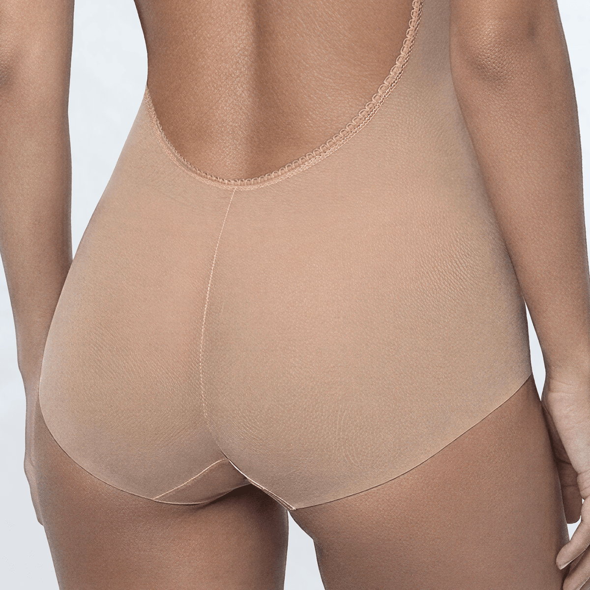 Ender Legard INCA Nude backless bodysuit close-up showing the finished low-back edge, centre-back seam and full brief coverage below.