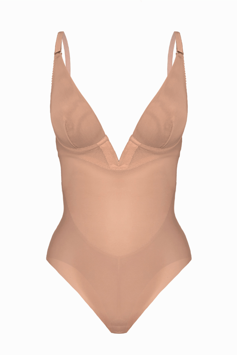 Beige backless bodysuit with thin straps on a white background as seen from front