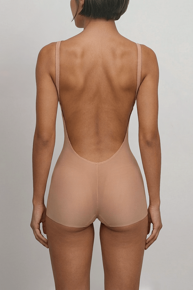 Backless shapewear bodysuit with deep U low back, seamless full brief and no VPL finish for invisible wear under dresses.