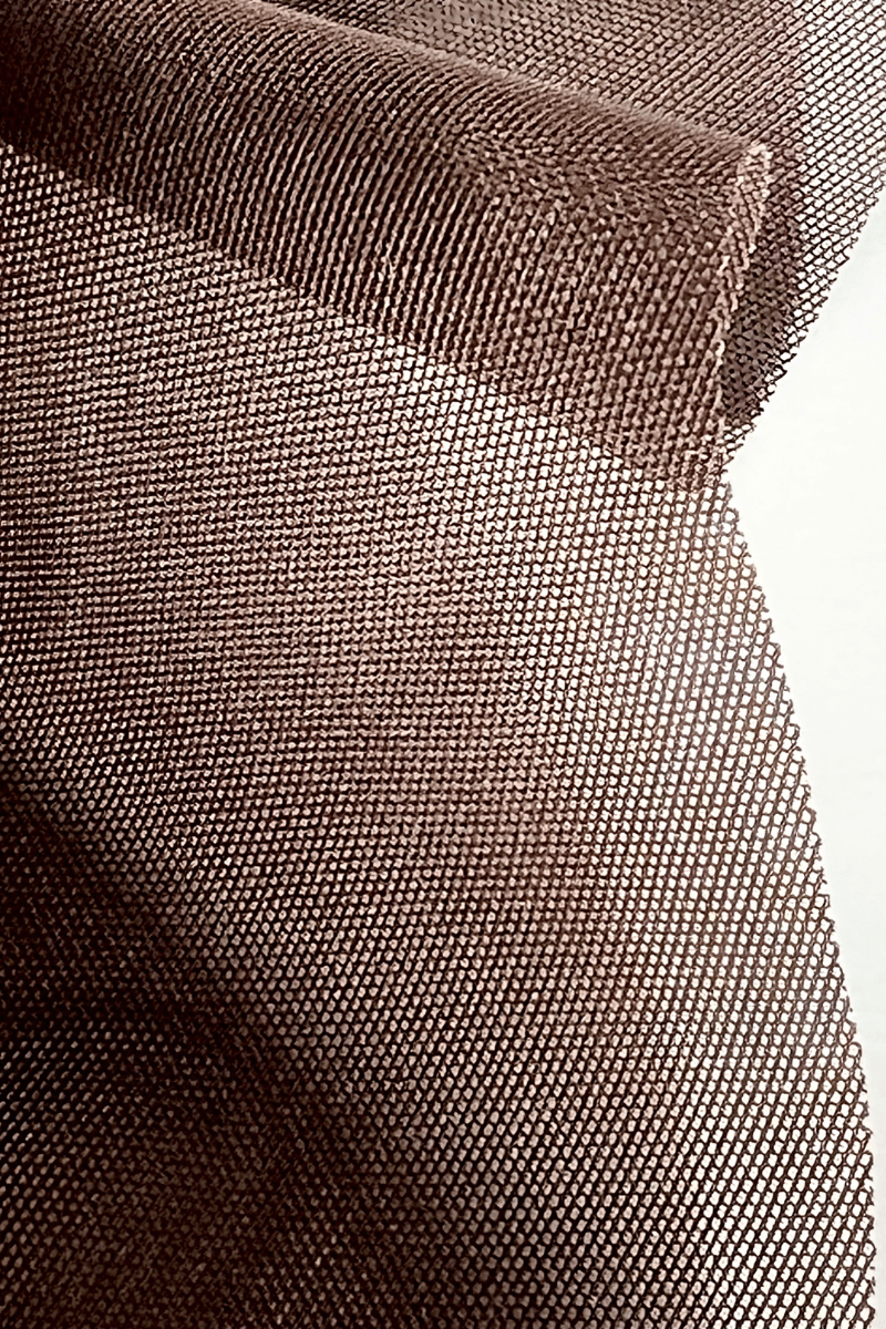 Close up of brown powernet fabric used in Ender Legard backless bodysuits