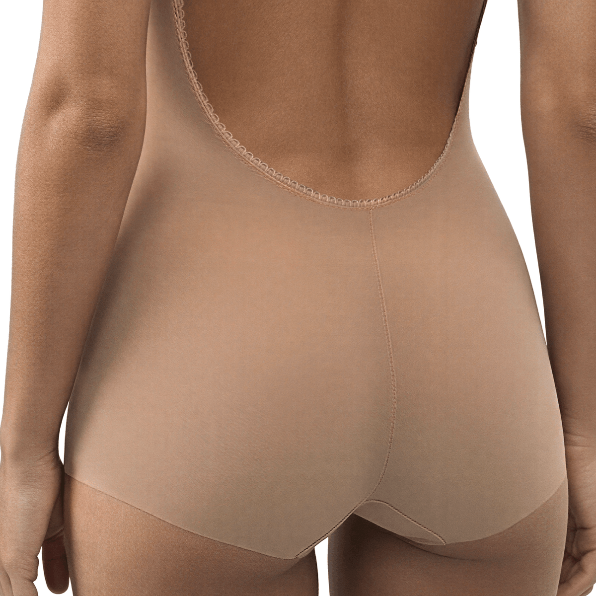 Close-up back view of the Ender Legard KYA Nude bodysuit showing the ultra-low scalloped back edge, centre-back seam and full-brief seat coverage with flat laser-cut leg edges.