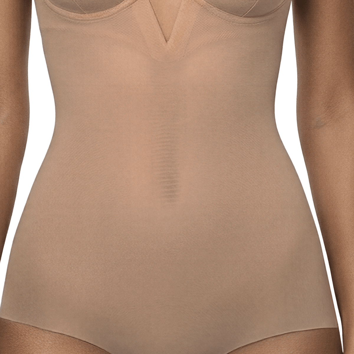 Close-up of the Ender Legard KYA Nude bodysuit showing the smooth power-mesh front panel across the waist and abdomen, continuing into the full briefs with flat front leg edges.