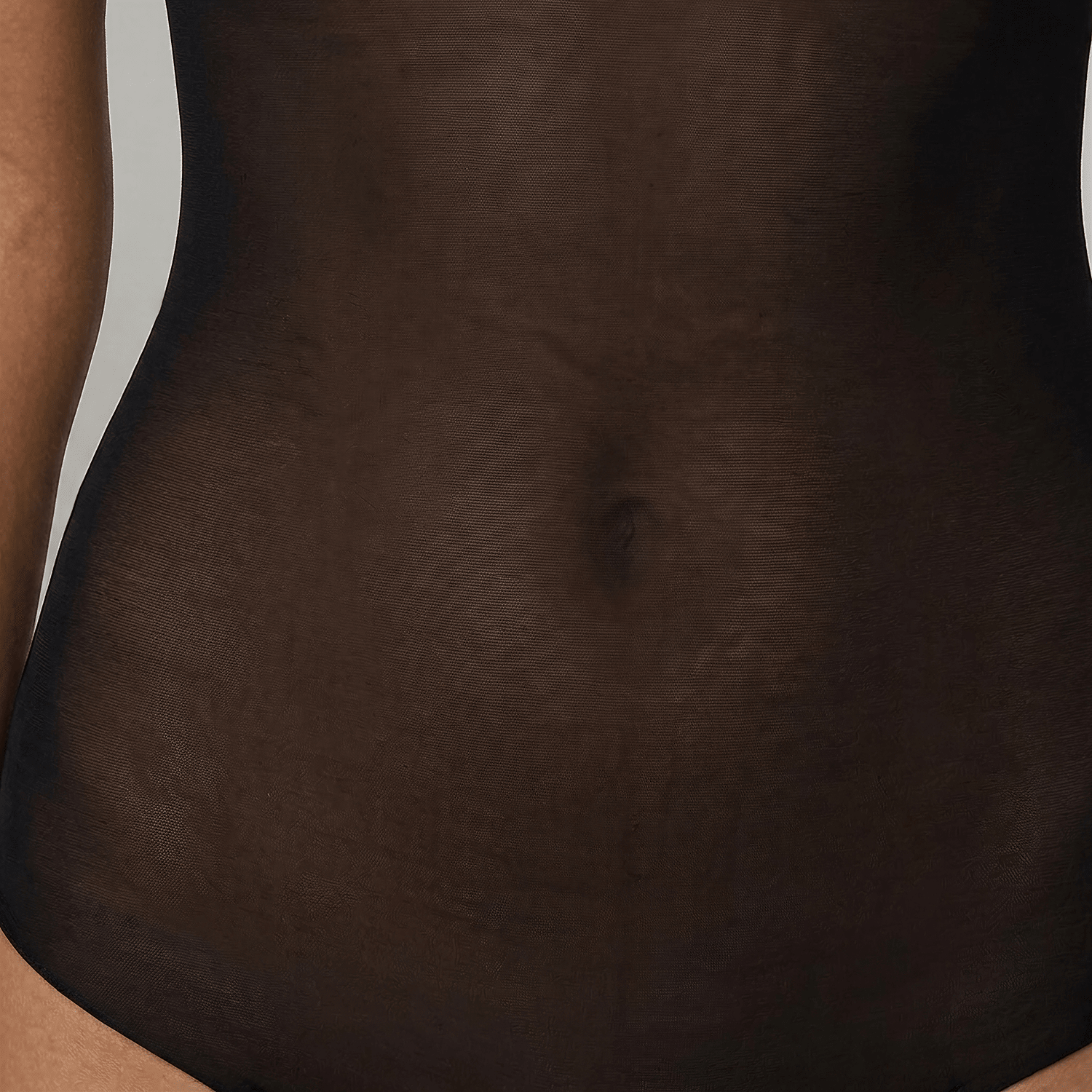 Close-up of the LIV Black bodysuit's sheer power-mesh front, covering the abdomen and belly button.