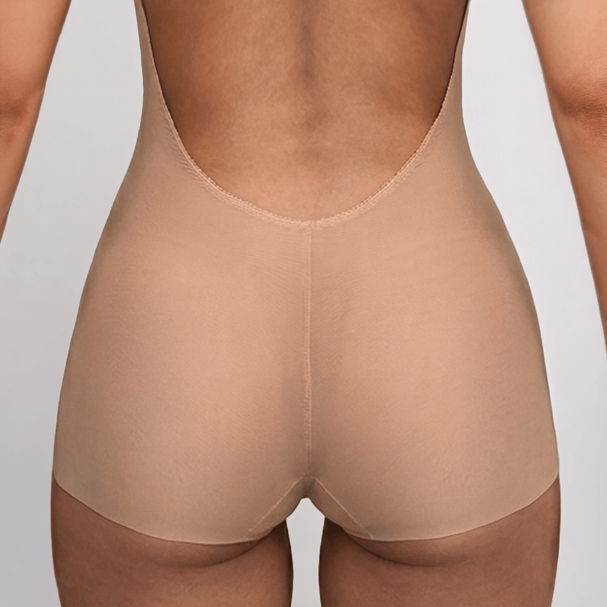 SIA Nude backless bodysuit close-up of the back, showing the full-brief construction with a laser-cut edge that sits flat at the leg opening.