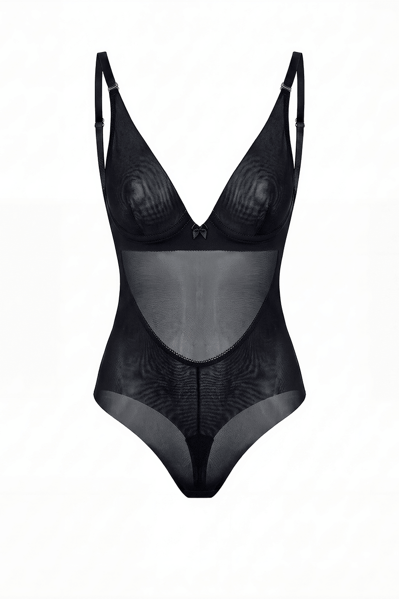 SKYE Black backless bodysuit shown unworn: the underwired V-front minimiser cup with a centre bow, adjustable shoulder straps, and high leg tanga briefs, with the low back visible through the sheer front panel.