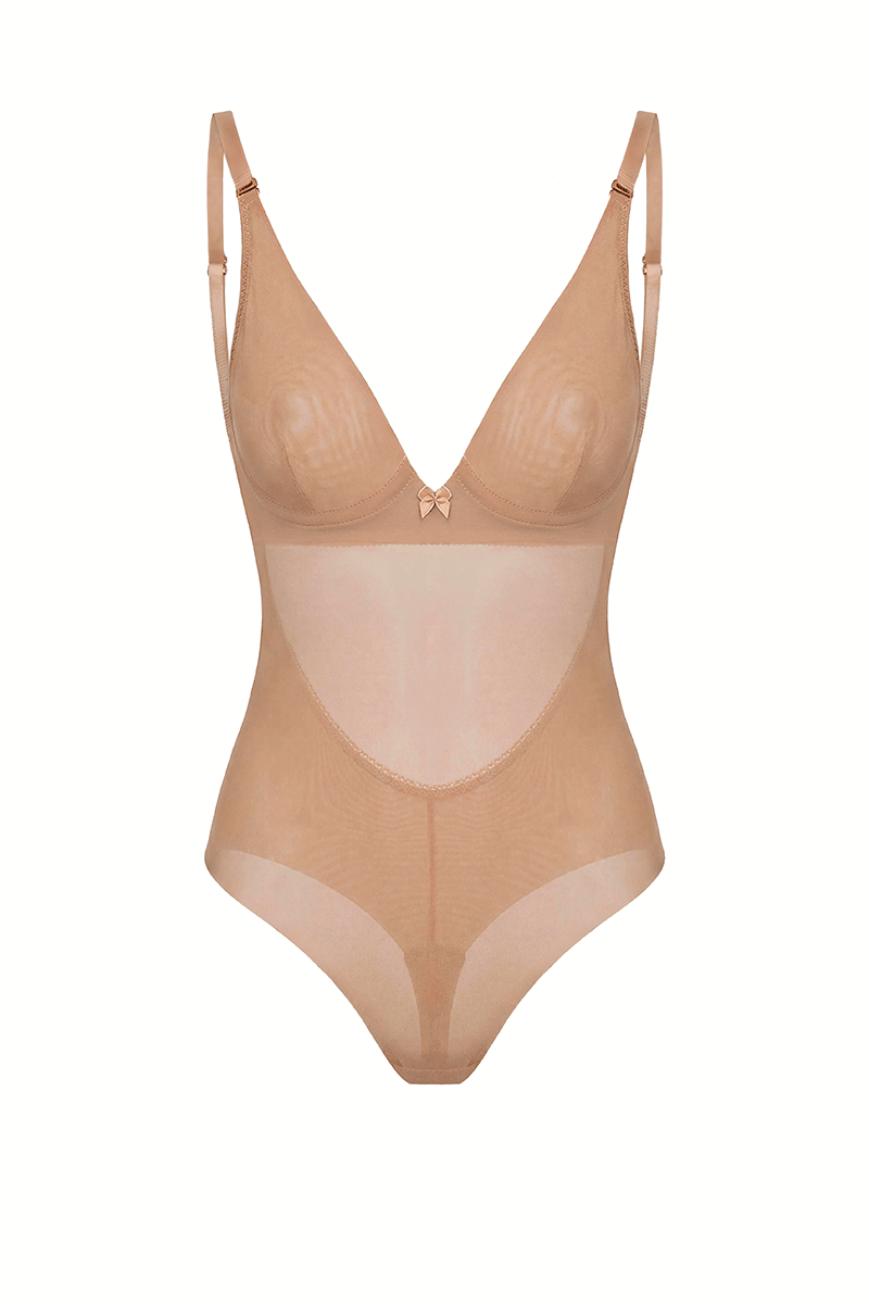 SKYE Nude backless bodysuit shown unworn: the underwired minimiser cup with centre dart seam and bow, adjustable shoulder straps, and high leg tanga briefs, with the low back visible through the sheer front panel.
