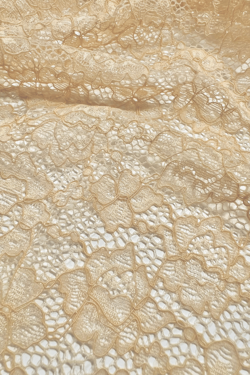 Close-up of the UMA Nude stretch lace fabric, showing the floral lace pattern and texture.