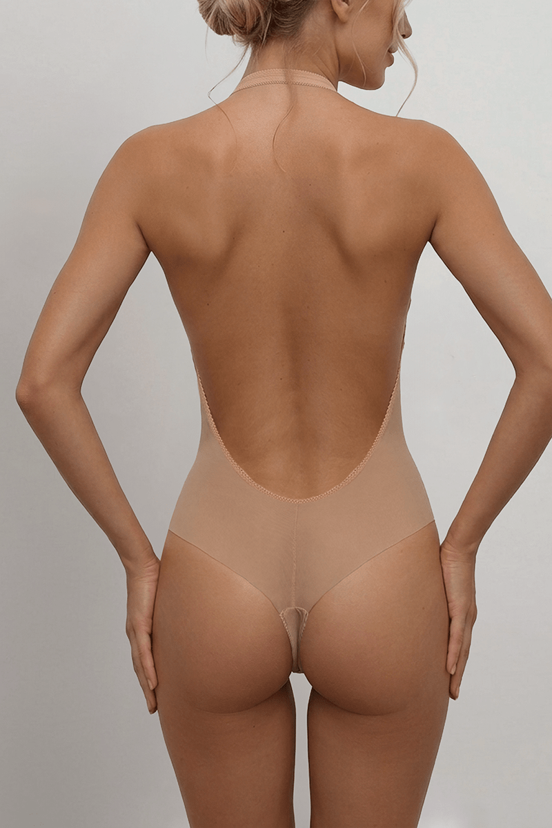 Nude backless halterneck bodysuit, laser-cut tanga brief, no-VPL seamless finish — disappears under sheer bridal gowns.