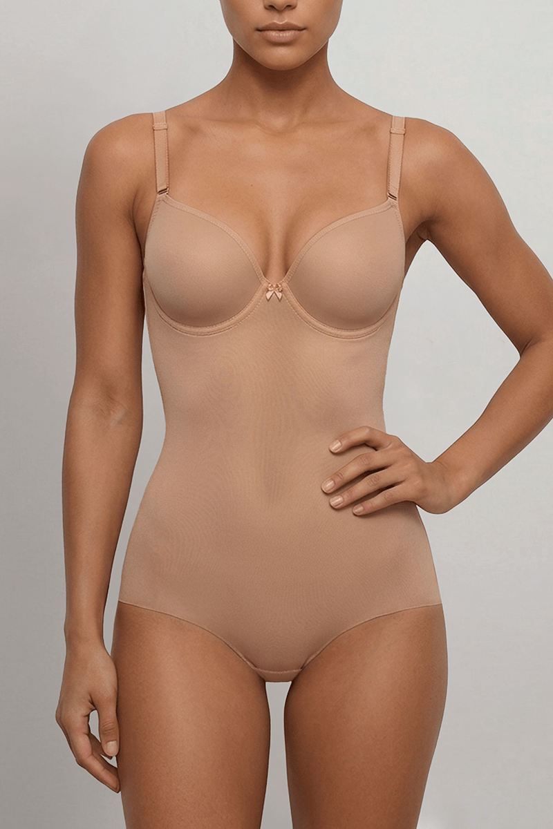 Nude backless bodysuit with structured underwired balconette cups delivers secure lift for fuller busts under low-back dresses.