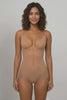 Seamless nude bodysuit with laser-cut edges provides invisible full-brief coverage under unlined low-back dresses.