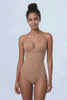SKYE Nude backless bodysuit shown in motion from the, worn alone then turns through a side profile showing the cut-away underarm construction and the high leg tanga cut, then turns fully to a back view showing the open low back with no bra back band.